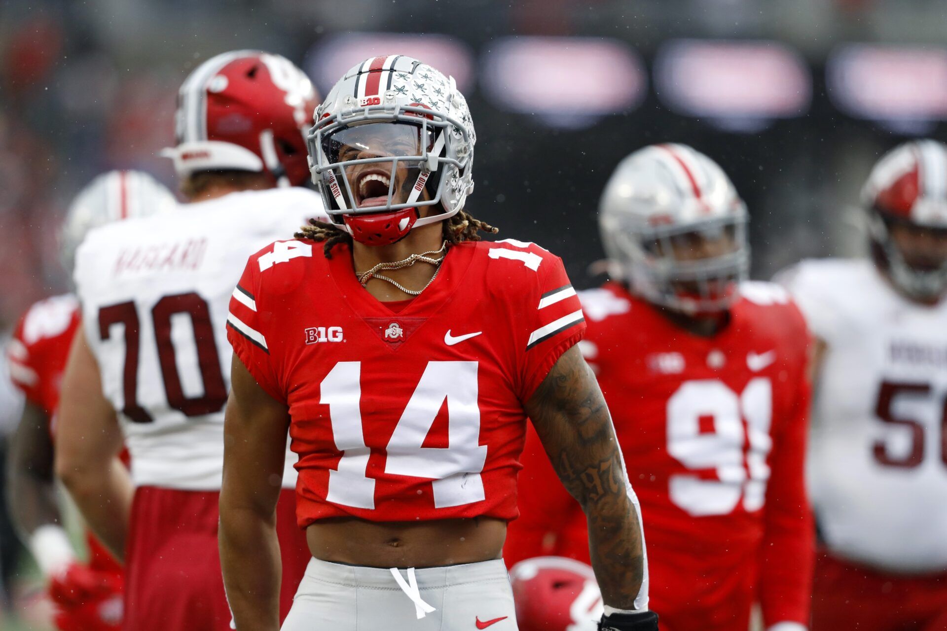 Ronnie Hickman celebrates making the tackle for loss on Indiana Hoosiers tight end AJ Barner.