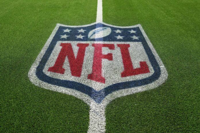 A detailed view of the NFL shield logo on the field at SoFi Stadium.