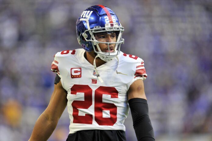 New York Giants running back Saquon Barkley (26) looks on during warmups before a wild card game against the Minnesota Vikings at U.S. Bank Stadium.