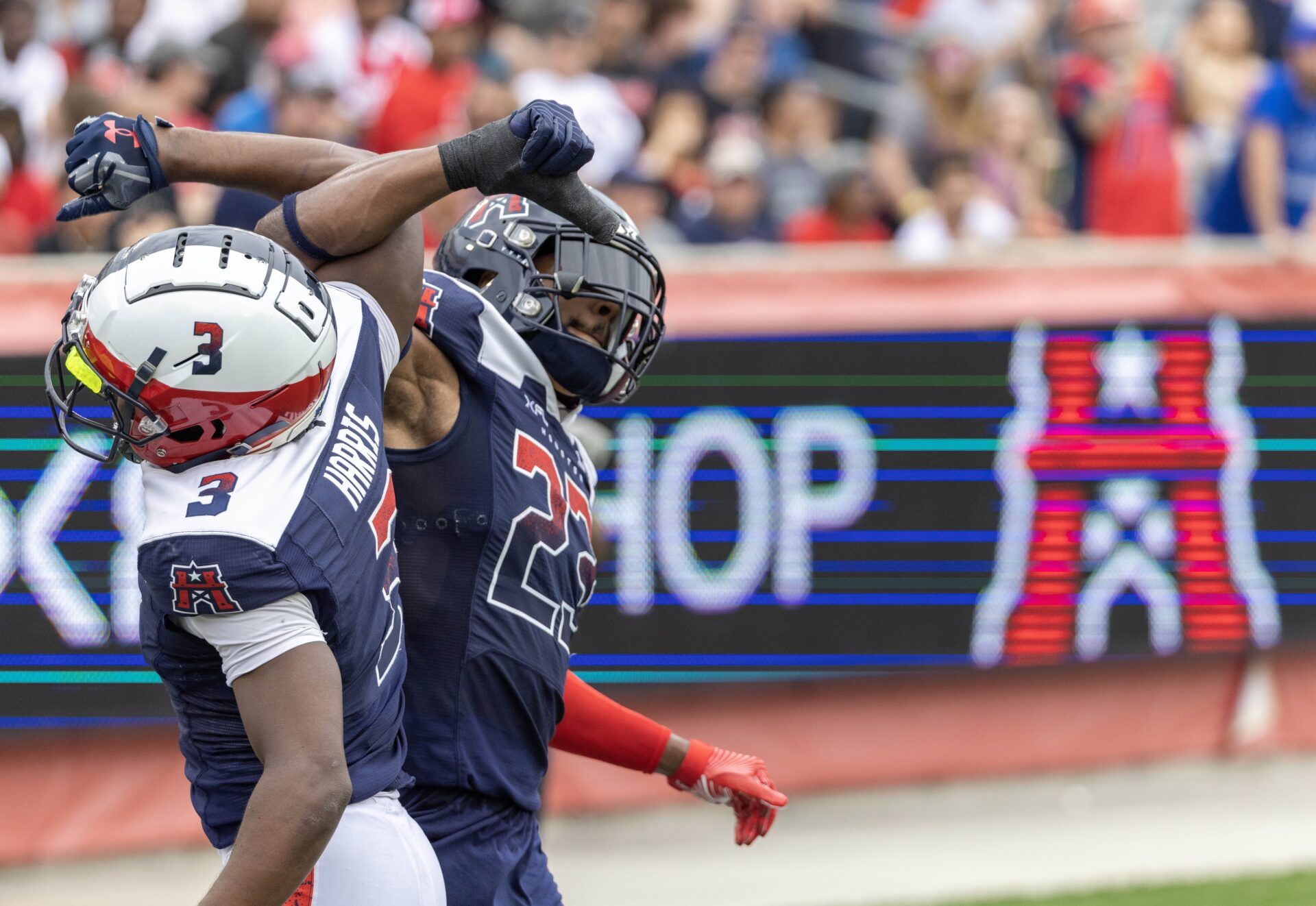 Houston Roughnecks defenders celebrate after a play against the Battlehawks.