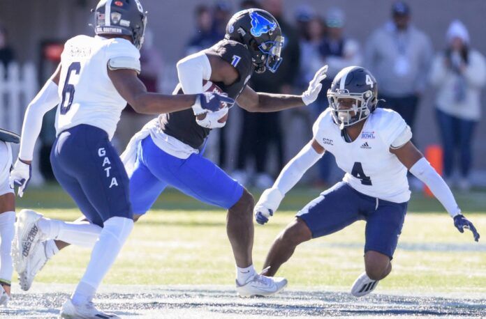 Buffalo wide receiver Justin Marshall (1) tries to avoid two Georgia Southern defenders.