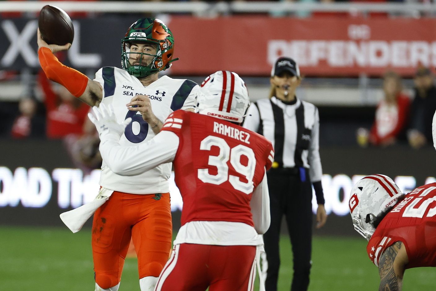 Seattle Sea Dragons QB Ben DiNucci (6) throws the ball as a DC Defender tries to defend.