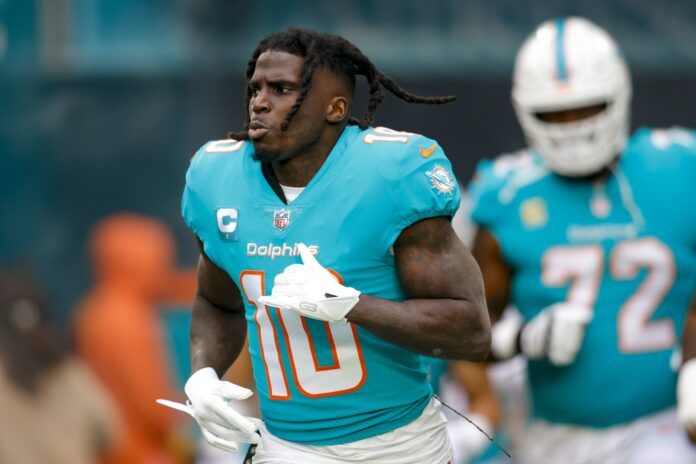 Miami Dolphins WR Tyreek Hill (10) runs out onto the field without his helmet.