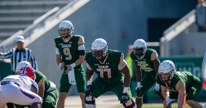 UAB OT Kadeem Telfort (77) and teammates line up prior to a play.