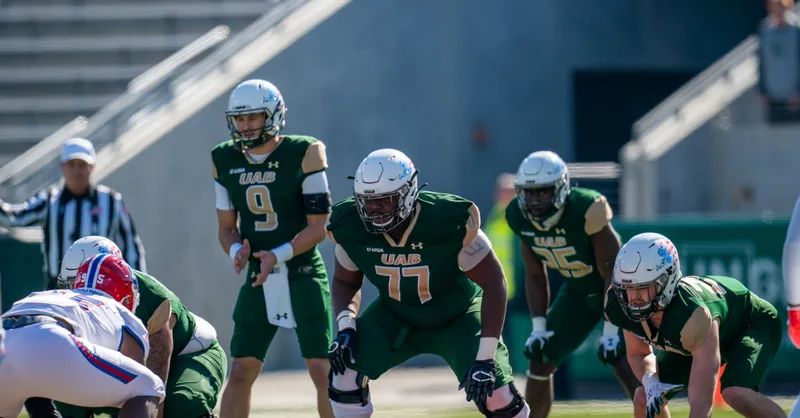 UAB OT Kadeem Telfort (77) and teammates line up prior to a play.