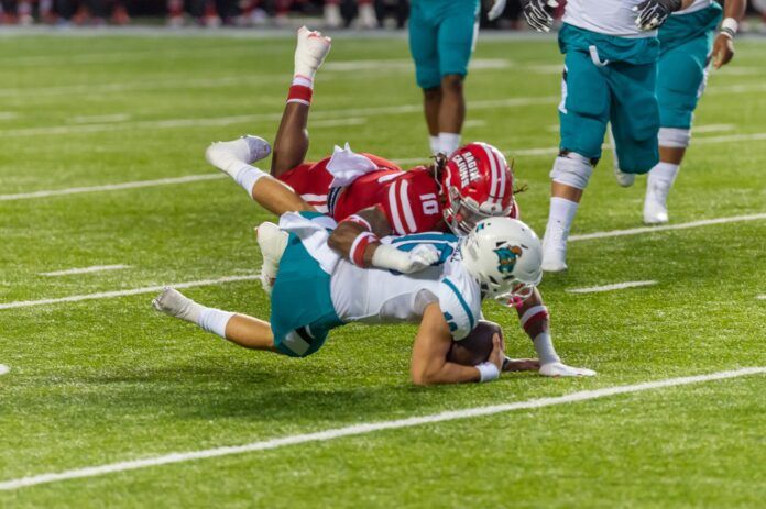 Louisiana EDGE Andre Jones (10) tackles Coastal Carolina QB Grayson McCall in the open field.