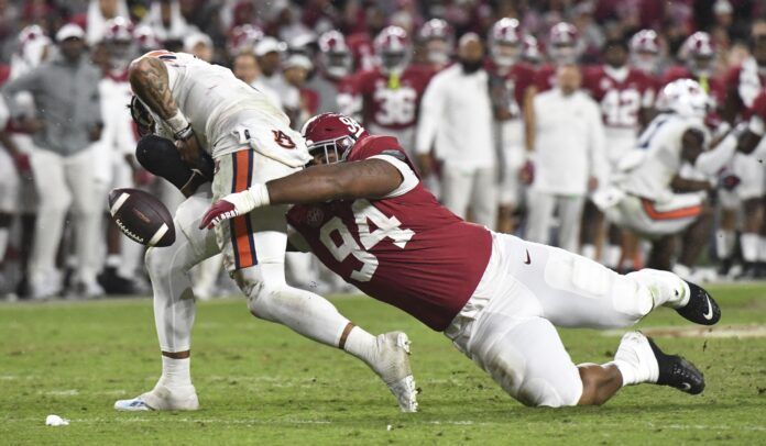 Alabama defensive tackle DJ Dale forces a fumble against Auburn QB Robby Ashford (9).