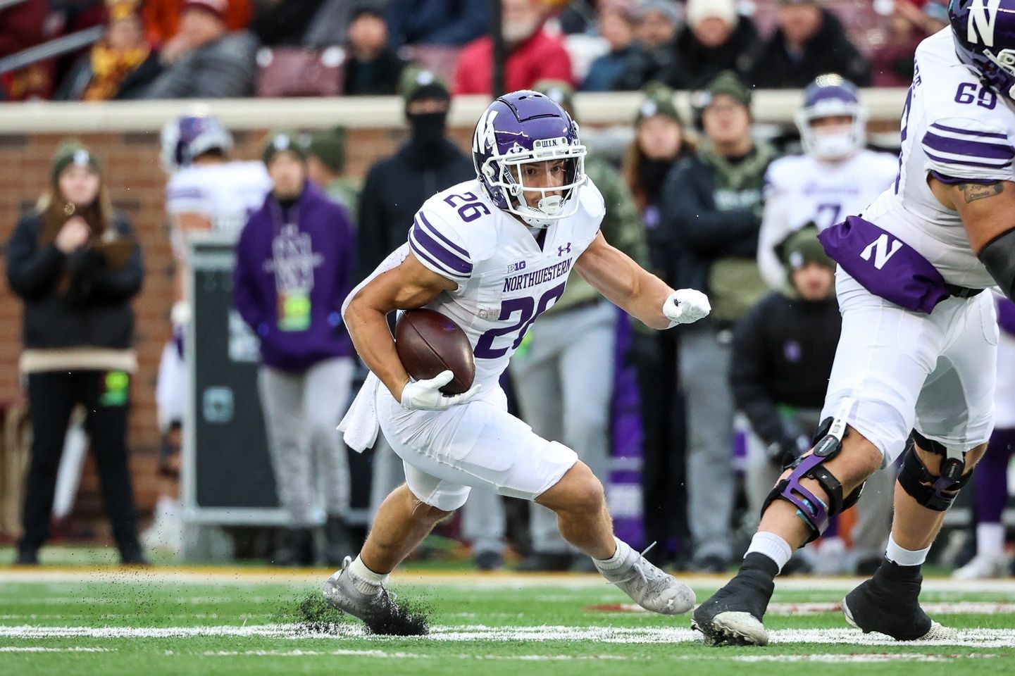 Northwestern running back Evan Hull (26) runs the ball against Minnesota.