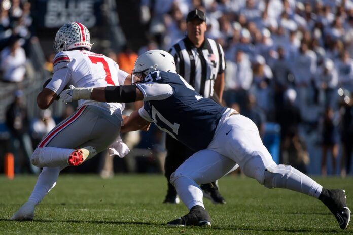 Penn State DT PJ Mustipher (97) tackles Ohio State QB C.J. Stroud (7).