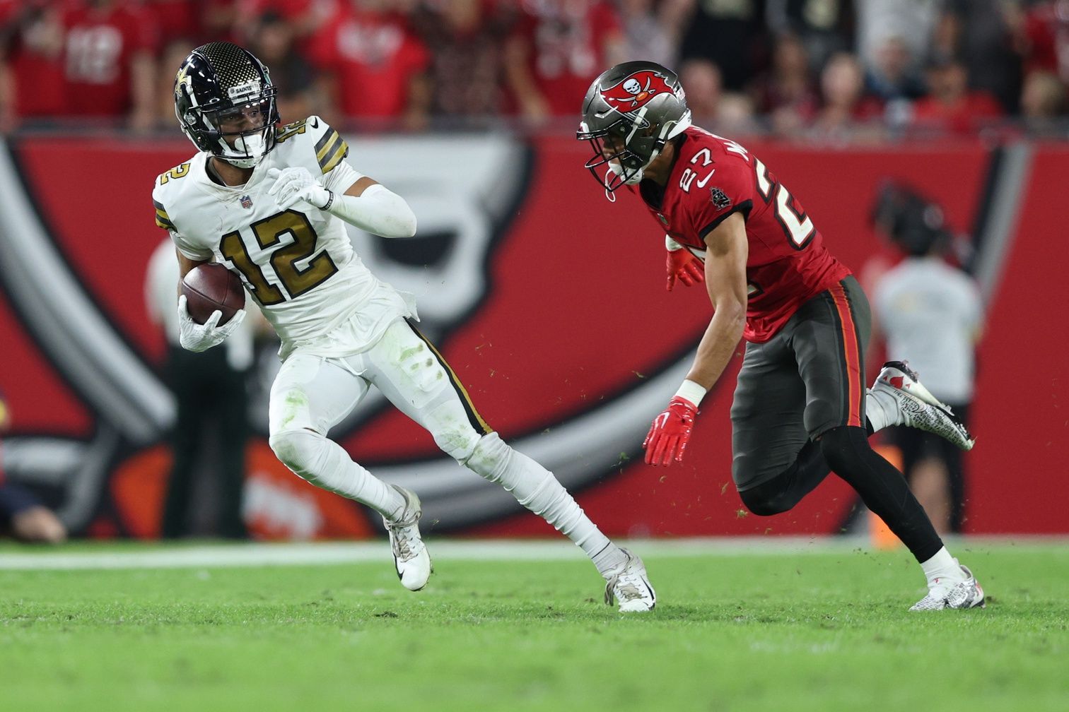 New Orleans Saints WR Chris Olave (12) looks to avoid the tackle against Tampa Bay.