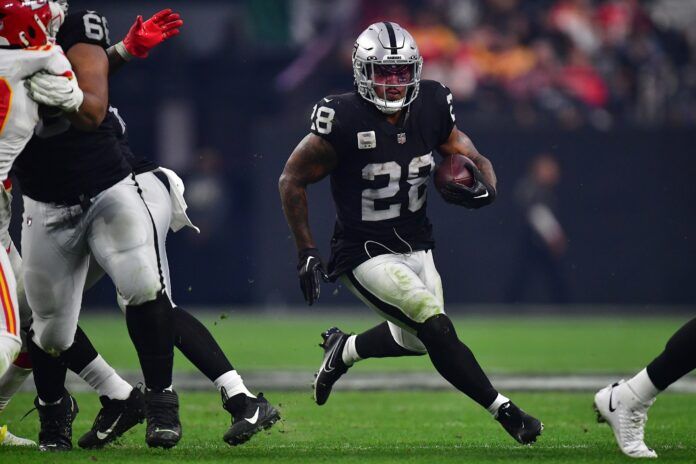 Josh Jacobs (28) runs the ball against the Kansas City Chiefs during the second half at Allegiant Stadium.