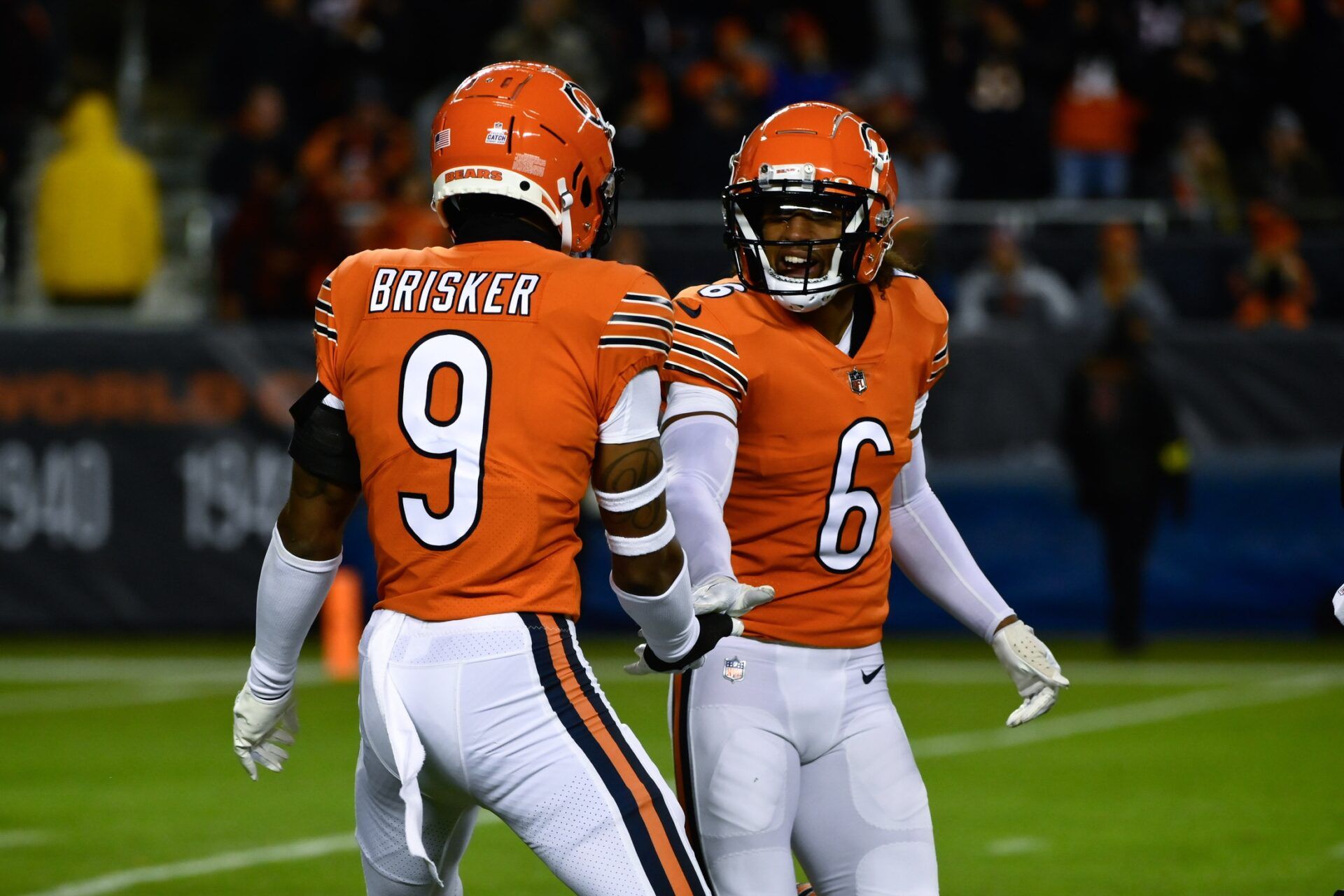 Chicago Bears DBs Jaquan Brisker (9) and Kyler Gordon (6) react after a play.