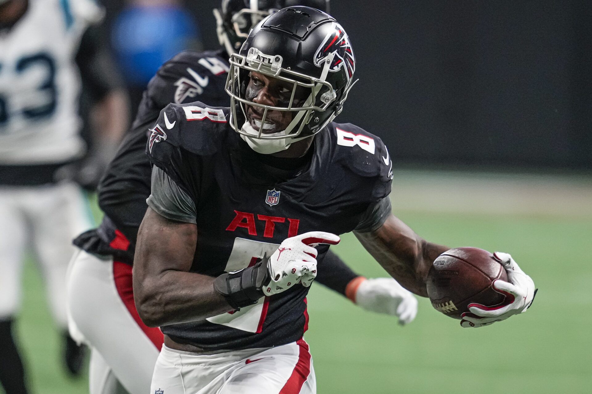 Kyle Pitts (8) runs after a catch against the Carolina Panthers during the second half at Mercedes-Benz Stadium.