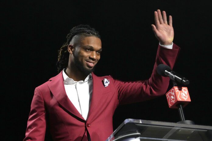 Buffalo Bills safety Damar Hamlin accepts the Alan Page Community Award during the NFLPA press conference.