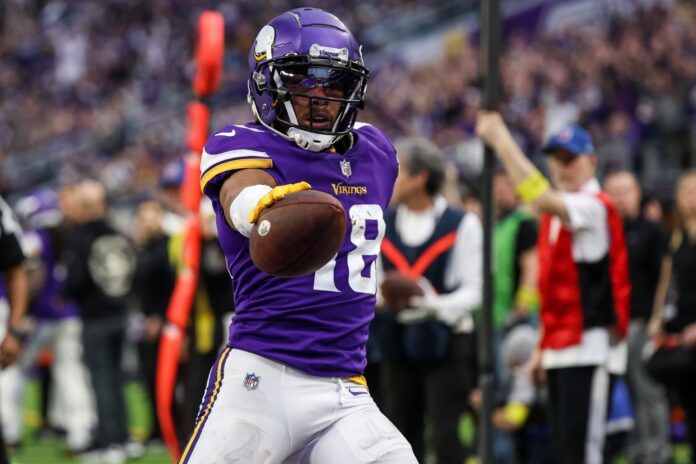 Justin Jefferson (18) makes a catch for a touchdown against the Indianapolis Colts during the fourth quarter at U.S. Bank Stadium.