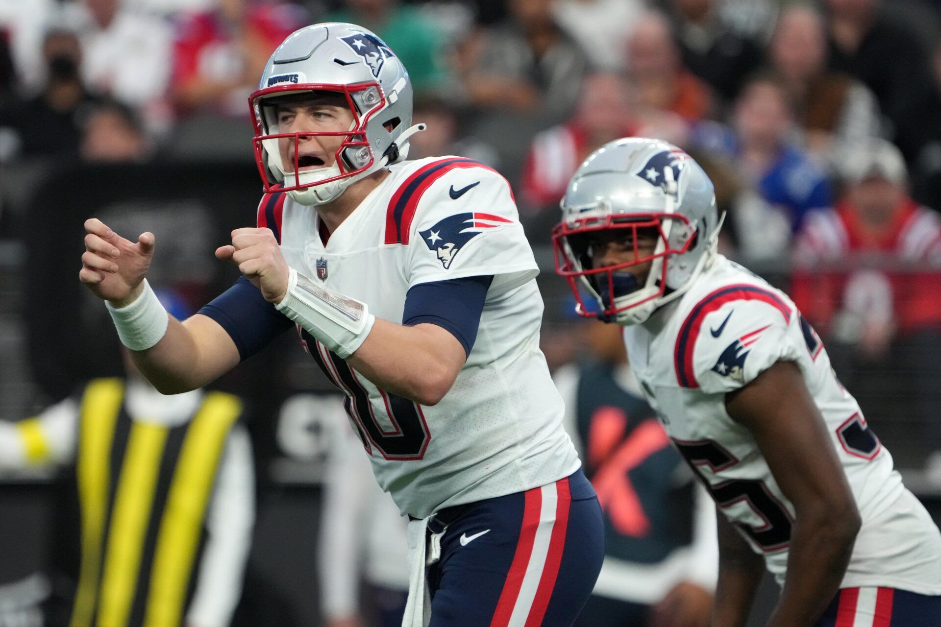 New England Patriots QB Mac Jones (10) reacts to the defense before a play against Las Vegas.