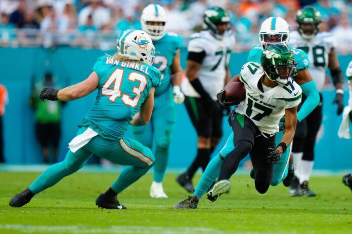 New York Jets WR Garrett Wilson (17) tries to evade Miami's Andrew Van Ginkel (43).