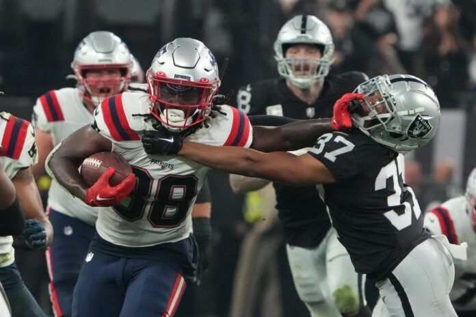 New England Patriots RB Rhamondre Stevenson (38) stiff-arms Raiders CB Tyler Hall (37).