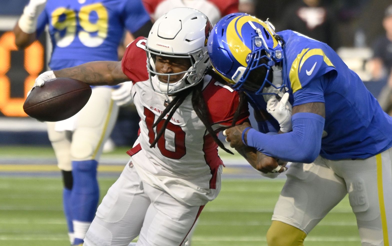 Arizona Cardinals WR DeAndre Hopkins (10) tries to avoid the tackle from Rams' CB Jalen Ramsey.