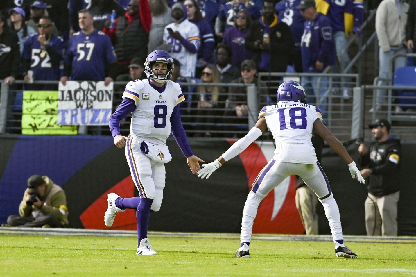 Minnesota Vikings QB Kirk Cousins (8) and Justin Jefferson (18) celebrate after scoring a touchdown.