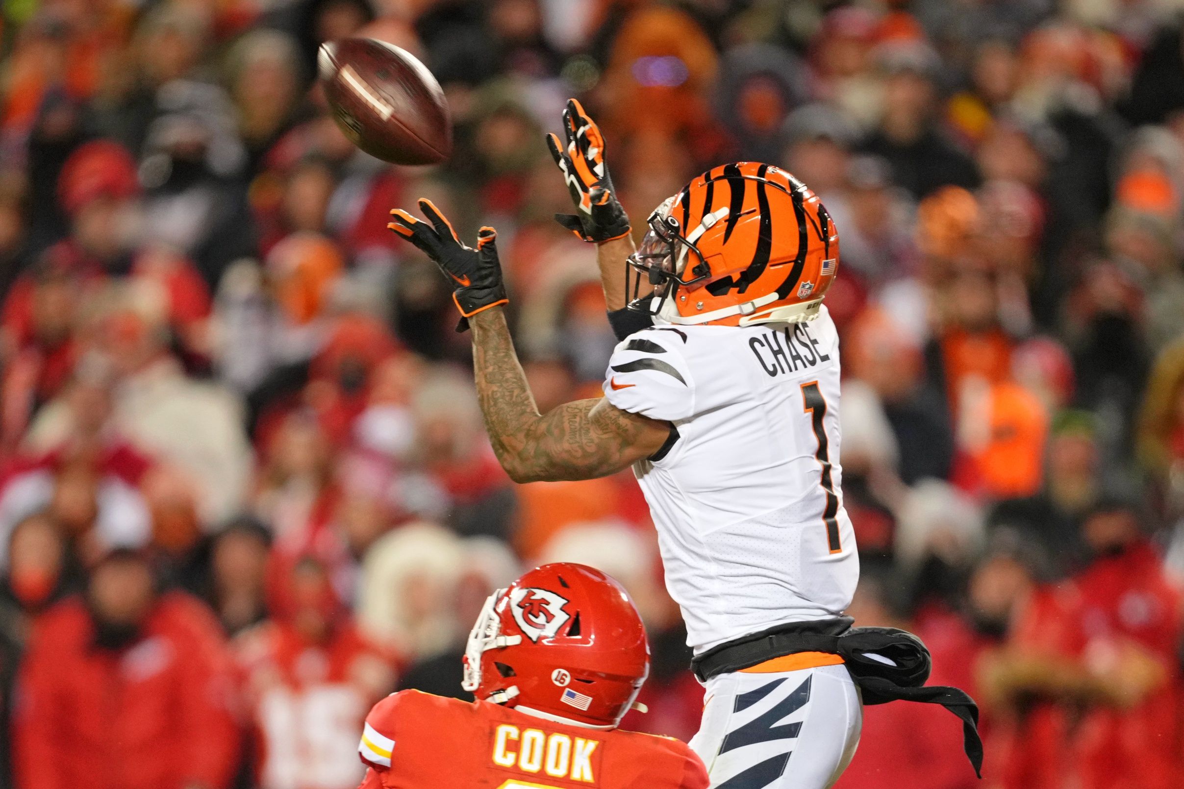 Ja'Marr Chase (1) makes a catch against Kansas City Chiefs safety Bryan Cook (6) during the third quarter of the AFC Championship Game at GEHA Field at Arrowhead Stadium.