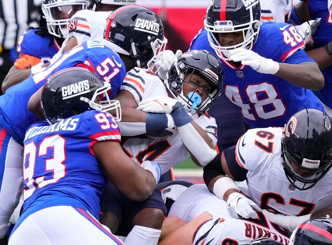 Khalil Herbert (24) is tackled by New York Giants defensive end Nick Williams (93 and linebacker Azeez Ojulari (51) and linebacker Tae Crowder (48) during the first quarter at MetLife Stadium.