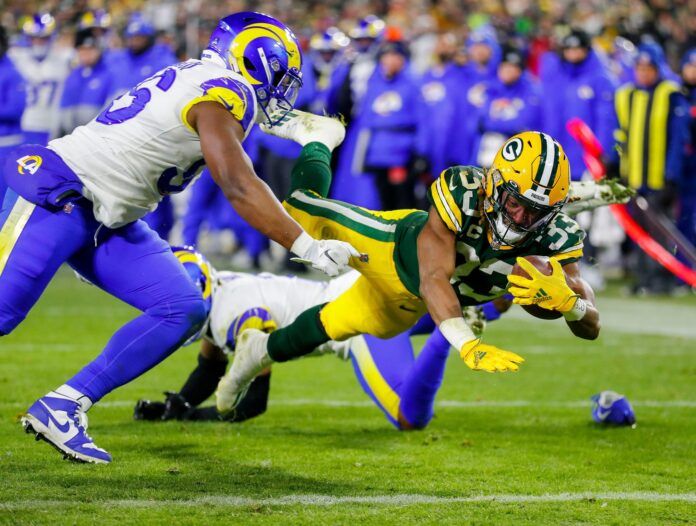 Aaron Jones (33) dives across the goal line for a touchdown against the Los Angeles Rams.