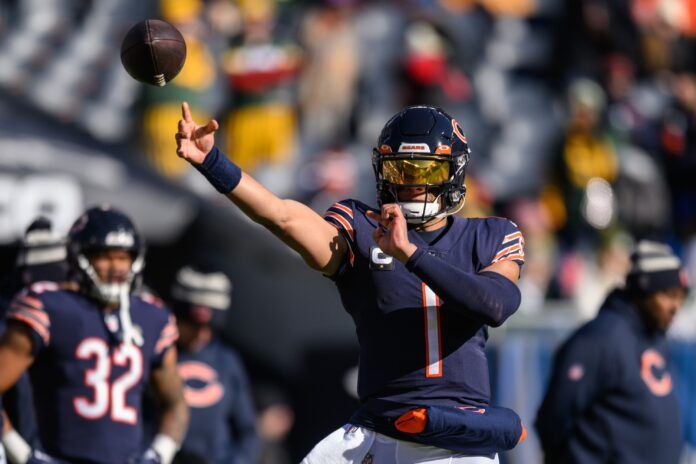 Justin Fields (1) warms up before the game against the Green Bay Packers at Soldier Field.