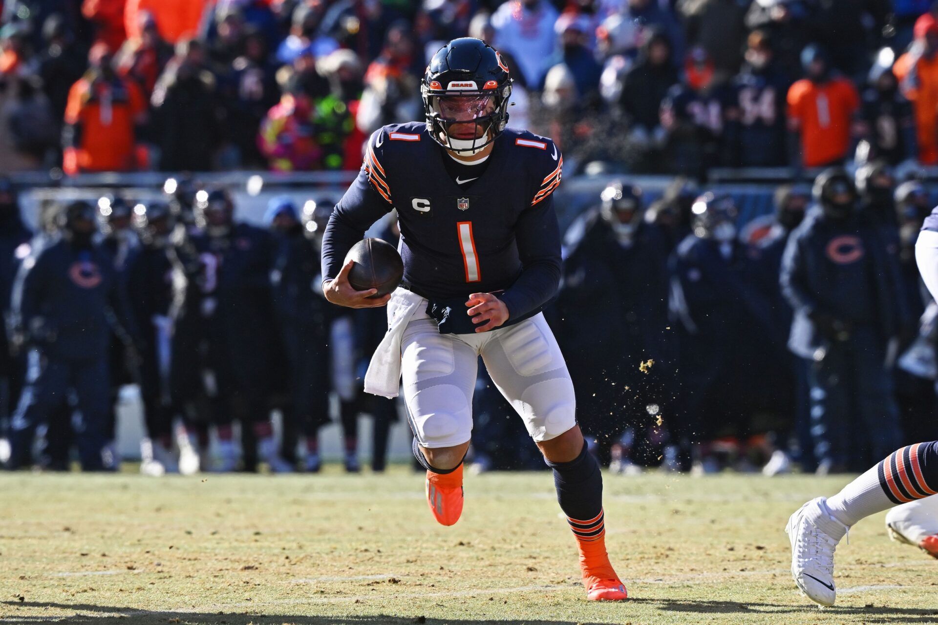 Justin Fields (1) runs with the ball against the Buffalo Bills at Soldier Field.