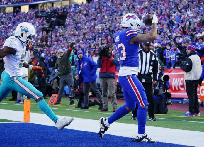 Gabe Davis (13) catches a touchdown pass against the Miami Dolphins during the second half in a NFL wild card game at Highmark Stadium.