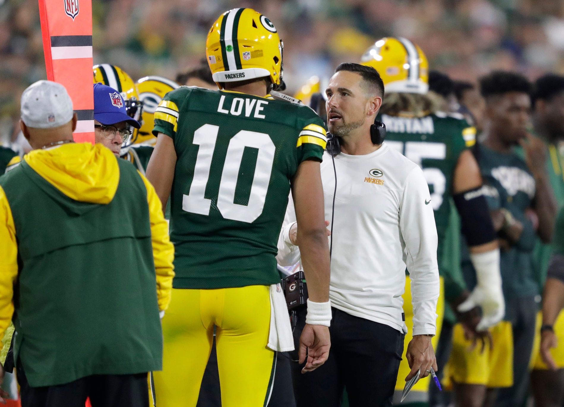 Green Bay Packers head coach Matt LaFleur and QB Jordan Love (10) talk on the sidelines during the game against the Saints.