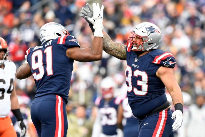 Deatrich Wise (91) and defensive end Lawrence Guy (93) react after a sack.