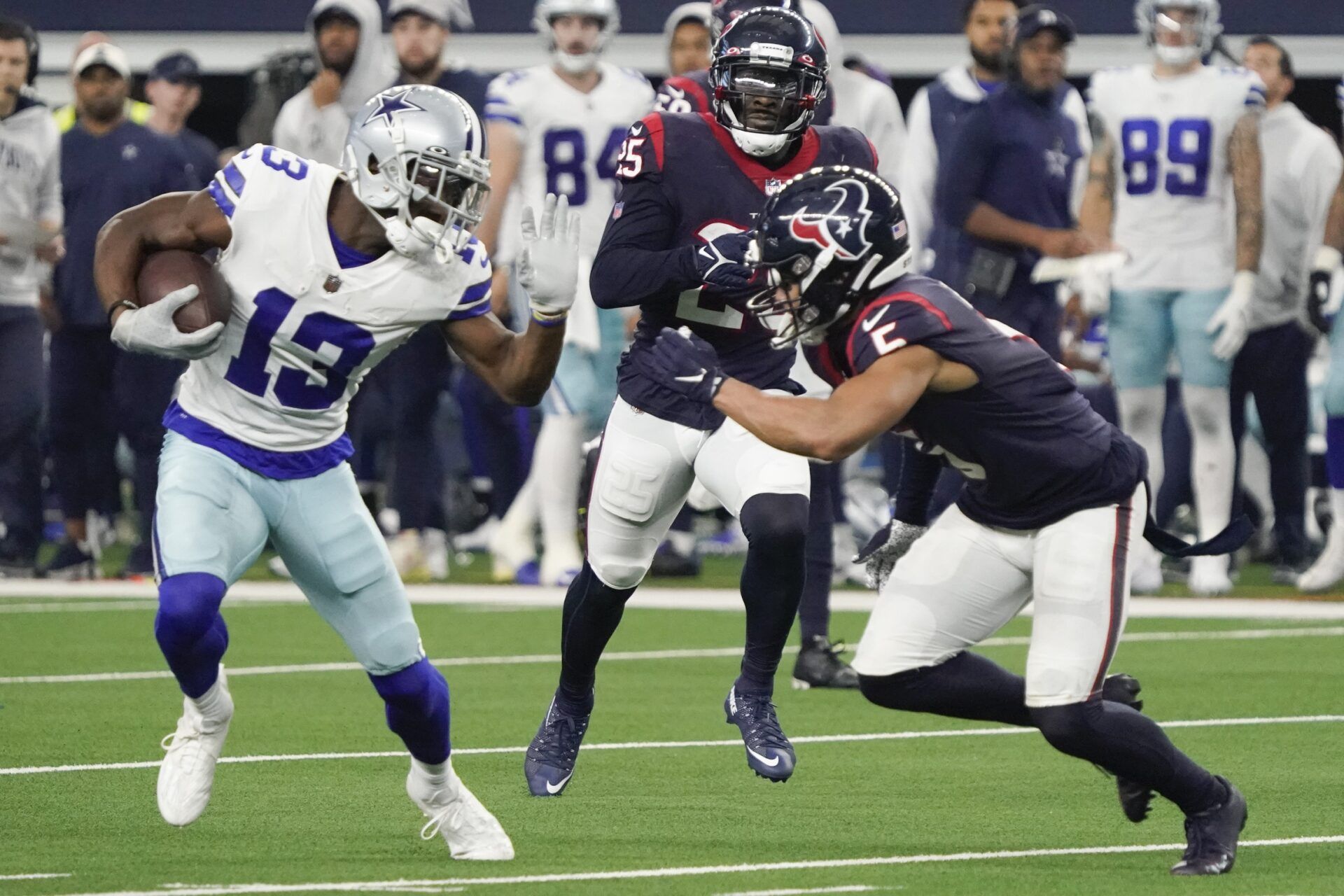 Dallas Cowboys WR Michael Gallup (13) tries to avoid the tackle against Houston.