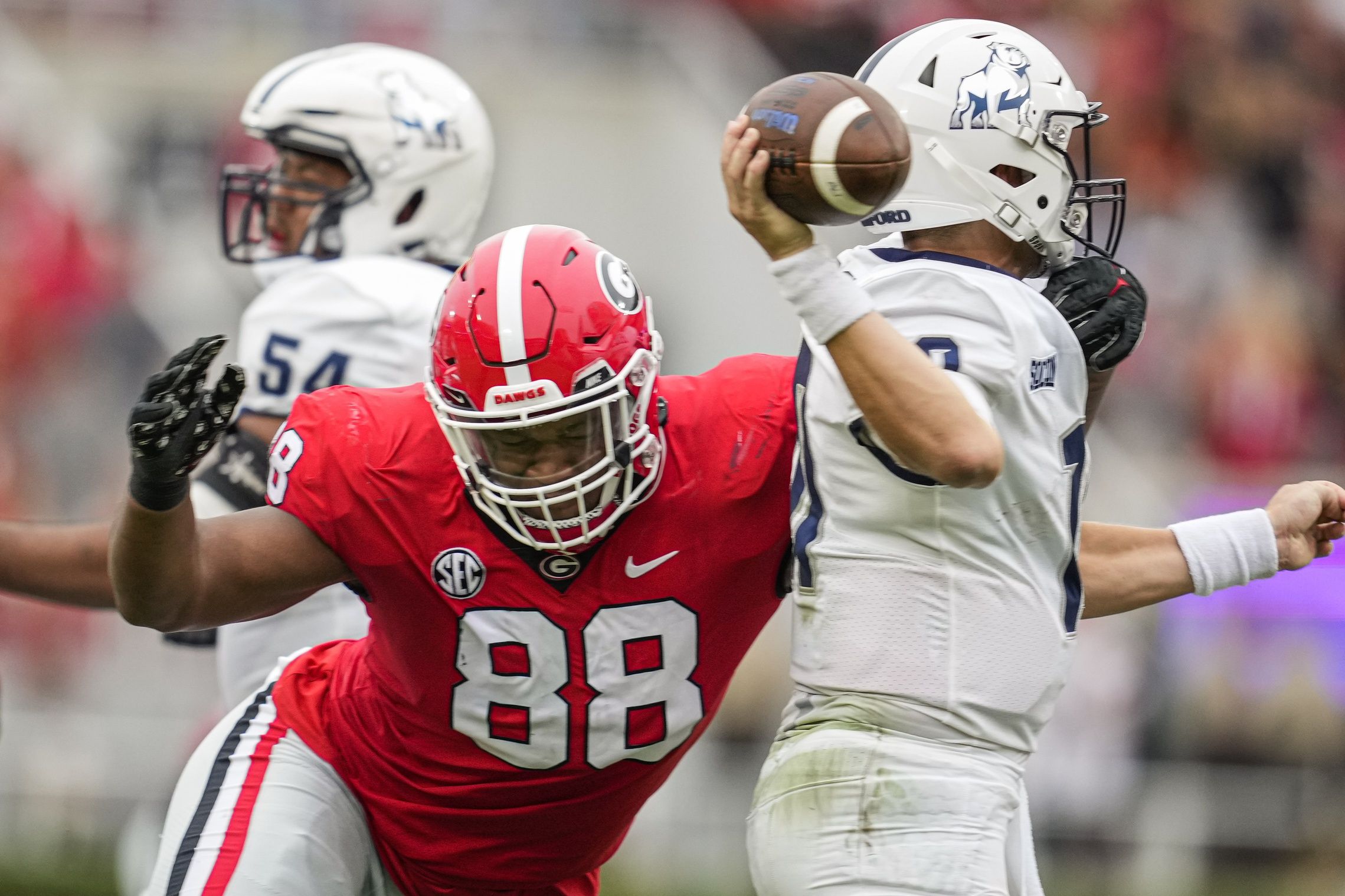 Former Georgia Bulldogs and current Philadelphia Eagles defensive lineman Jalen Carter (88) hits Samford Bulldogs quarterback Michael Hiers (10) during the first half at Sanford Stadium.