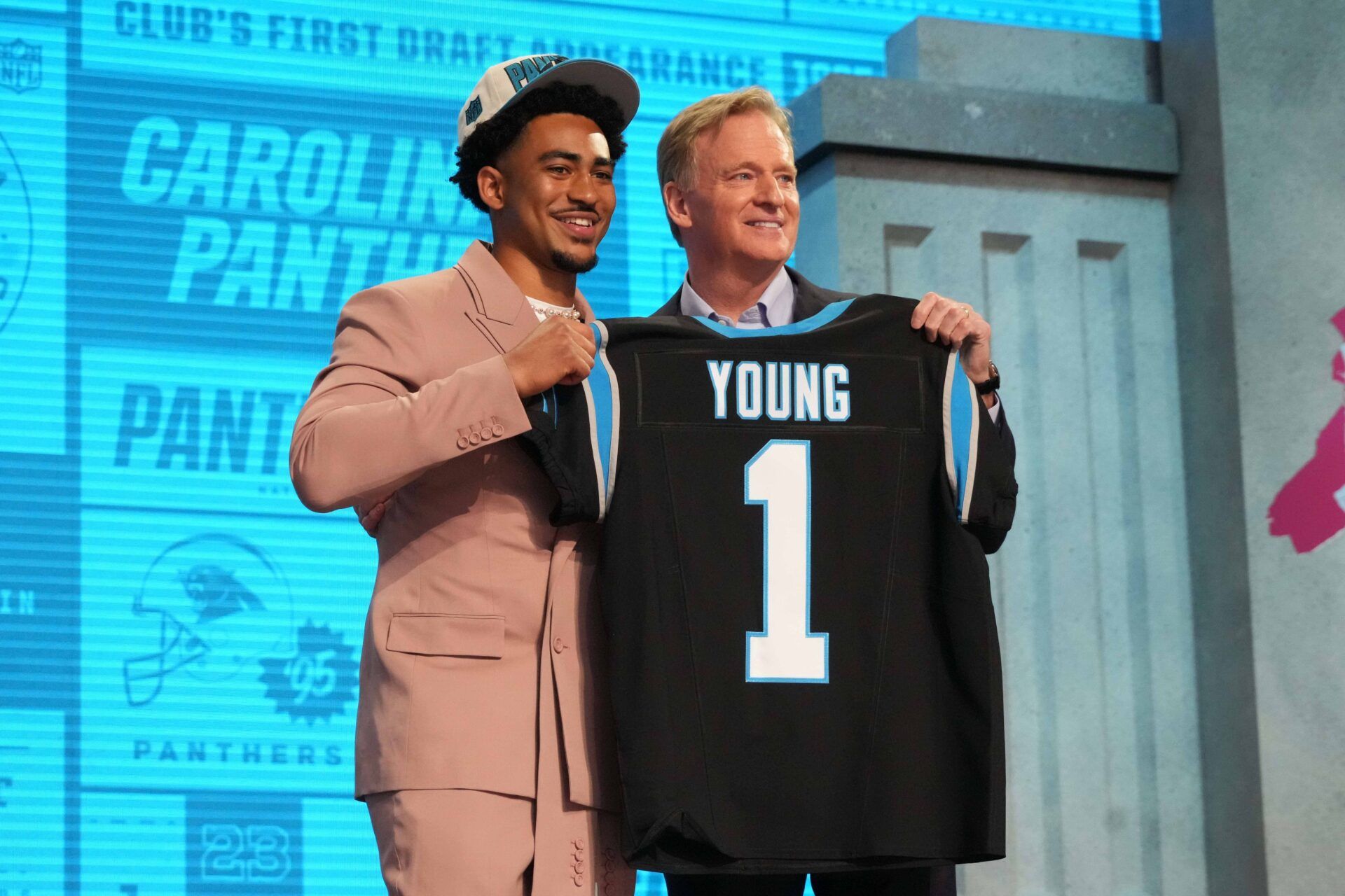 NFL Commissioner Roger Goodell and QB Bryce Young pose for pictures with Young's jersey after the Carolina Panthers selected him No. 1 overall.