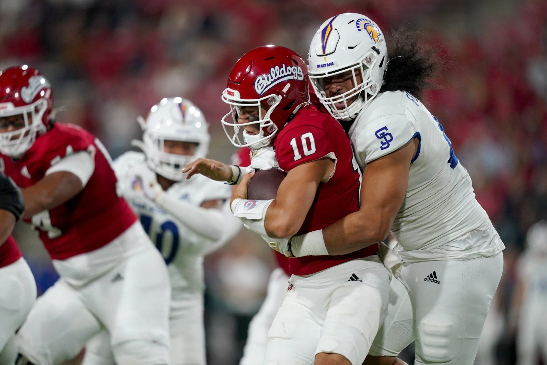 DL Viliami Fehoko (42) sacks Fresno State QB Logan Fife (10).