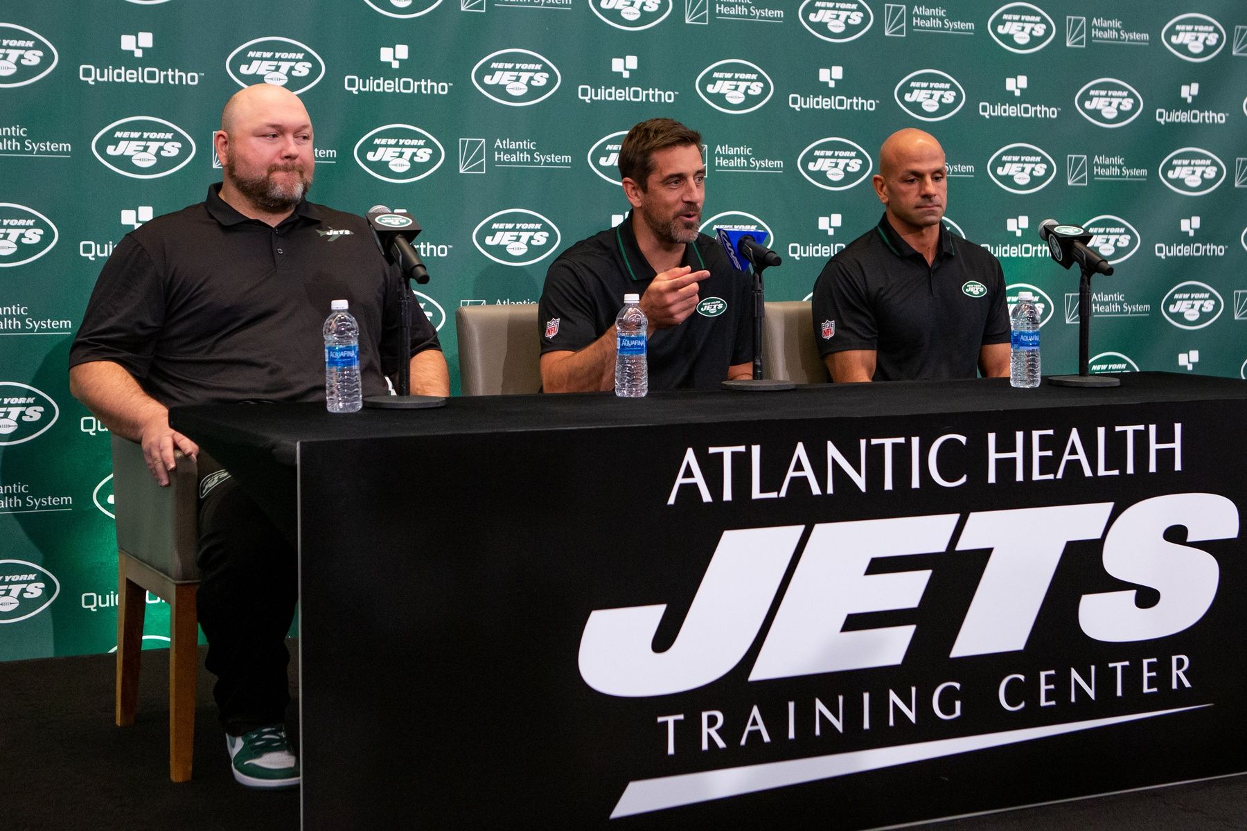 New York Jets GM Joe Douglas (left), QB Aaron Rodgers (middle), and HC Robert Saleh (right) talk to the media at a introductory press conference.