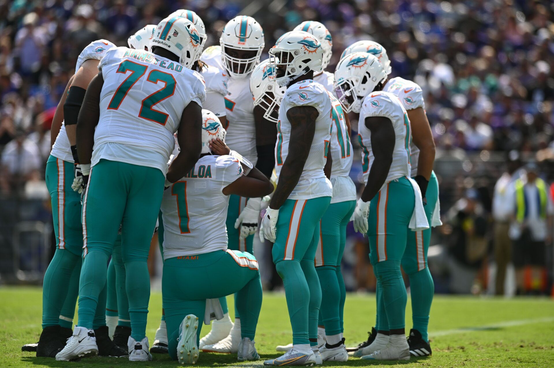 Tua Tagovailoa (1) calls a play in he huddle during the game against the Baltimore Ravens at M&T Bank Stadium.