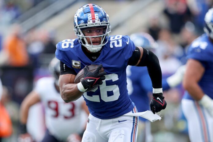 New York Giants running back Saquon Barkley (26) runs with the ball against the Houston Texans.