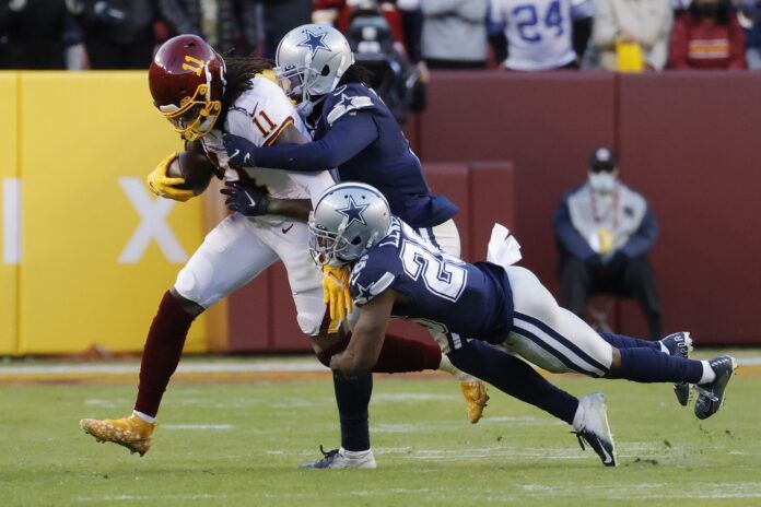 Dallas Cowboys cornerbacks Trevon Diggs (7) and Jourdan Lewis (26) tackle Washington WR Cam Sims (11).