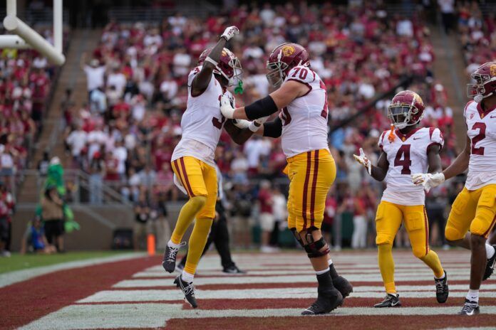 USC Trojans offensive lineman Bobby Haskins (70) celebrates with wide receiver Jordan Addison (3) after scoring a touchdown during the first quarter against the Stanford Cardinal at Stanford Stadium.