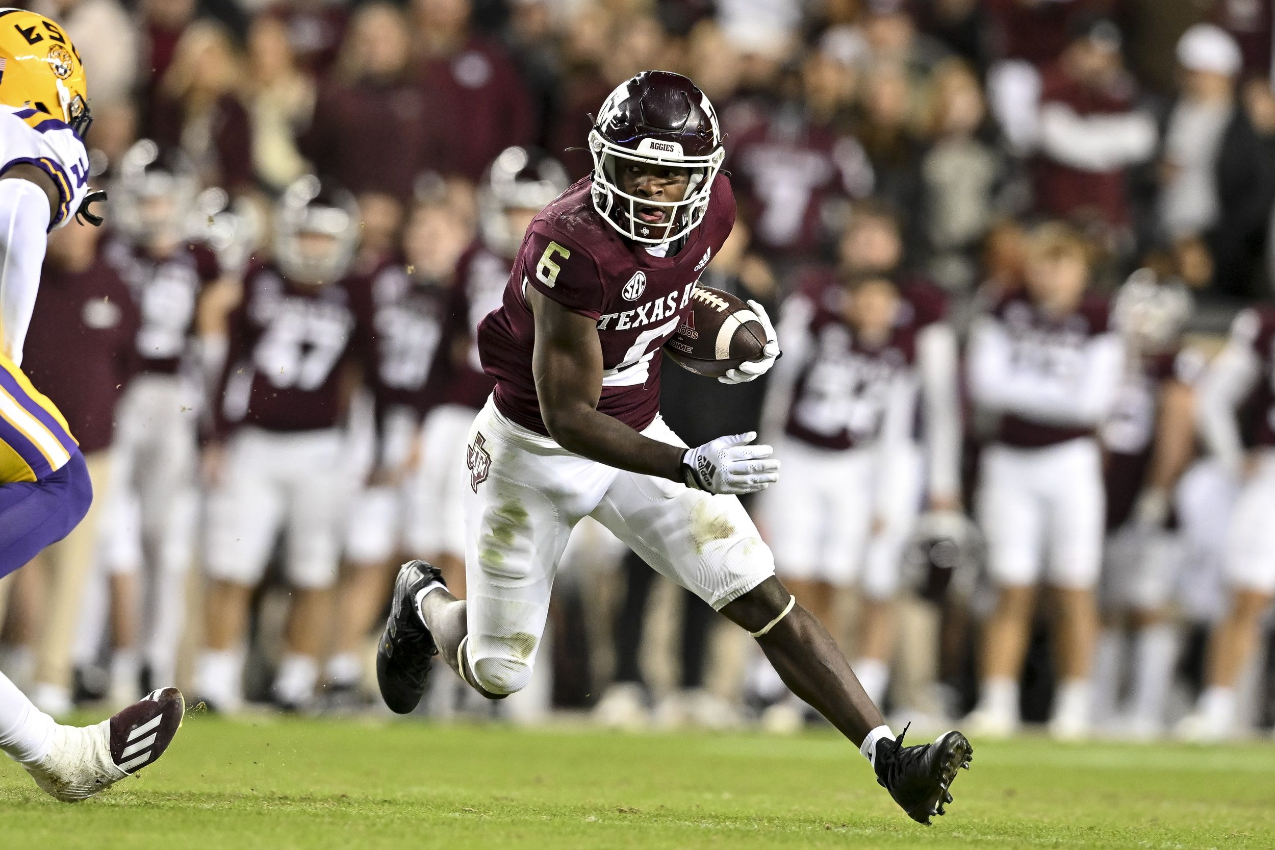 Texas A&M Aggies running back Devon Achane (6) runs the ball during the second quarter against the LSU Tigers at Kyle Field.