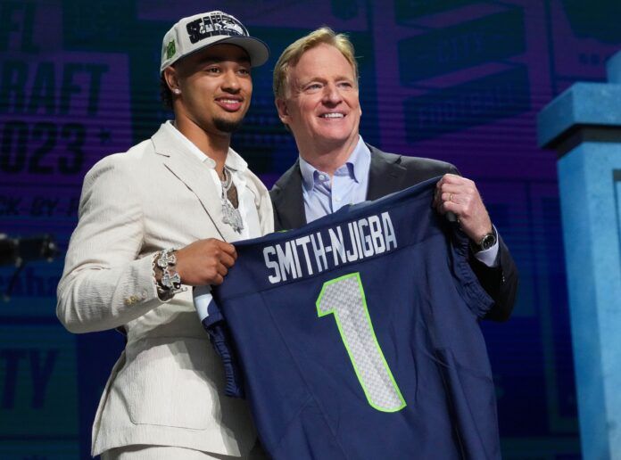 Jaxon Smith-Njigba with NFL commissioner Roger Goodell after being selected by the Seattle Seahawks twentieth overall in the first round of the 2023 NFL Draft at Union Station.