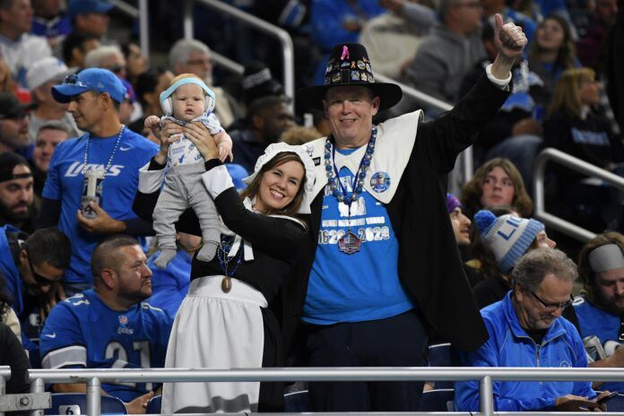 Detroit Lions fans cheer and get into the spirit of Thanksgiving during the game.