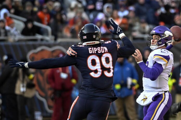 Minnesota Vikings quarterback Nick Mullens (12) throws against Chicago Bears linebacker Trevis Gipson (99) during the second half at Soldier Field.