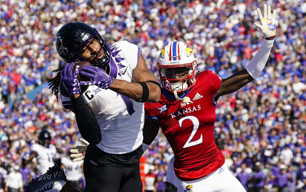 Quentin Johnston (1) catches a touchdown pass against Kansas Jayhawks cornerback Cobee Bryant (2) during the second half at David Booth Kansas Memorial Stadium.