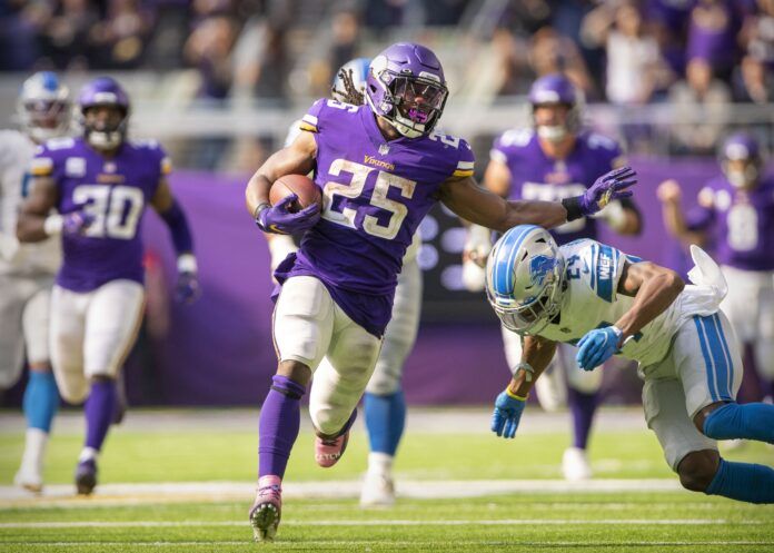 Minnesota Vikings RB Alexander Mattison (25) runs past the Detroit Lions' defense.