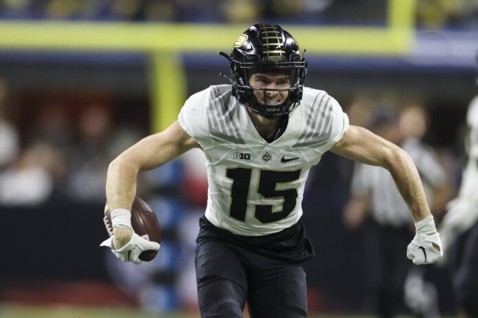 Charlie Jones (15) reacts after a long reception during the first half of the Big Ten Championship against the Michigan Wolverines at Lucas Oil Stadium.