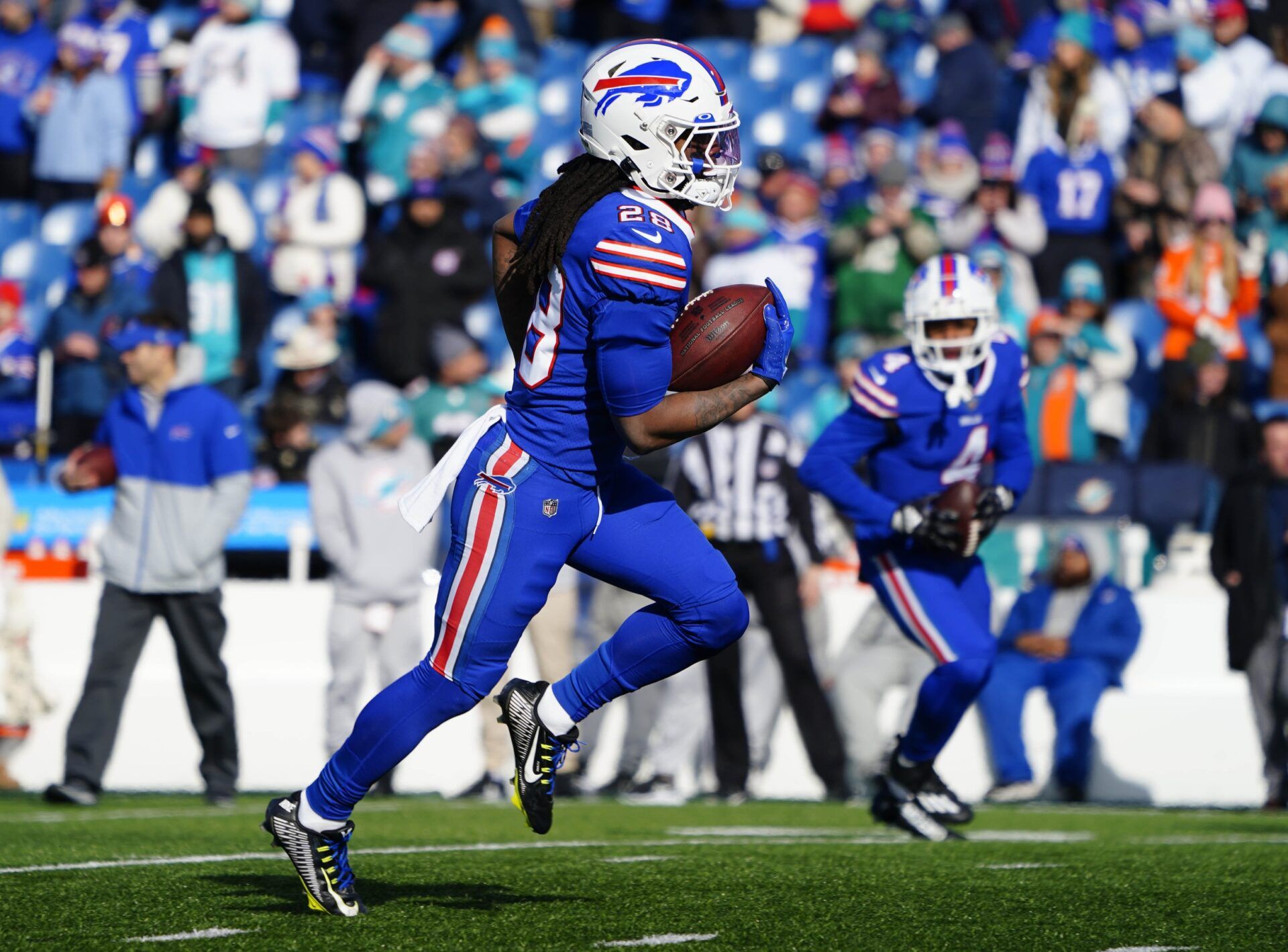 James Cook (28) warms up before playing against the Miami Dolphins in a NFL Wild Card game at Highmark Stadium.
