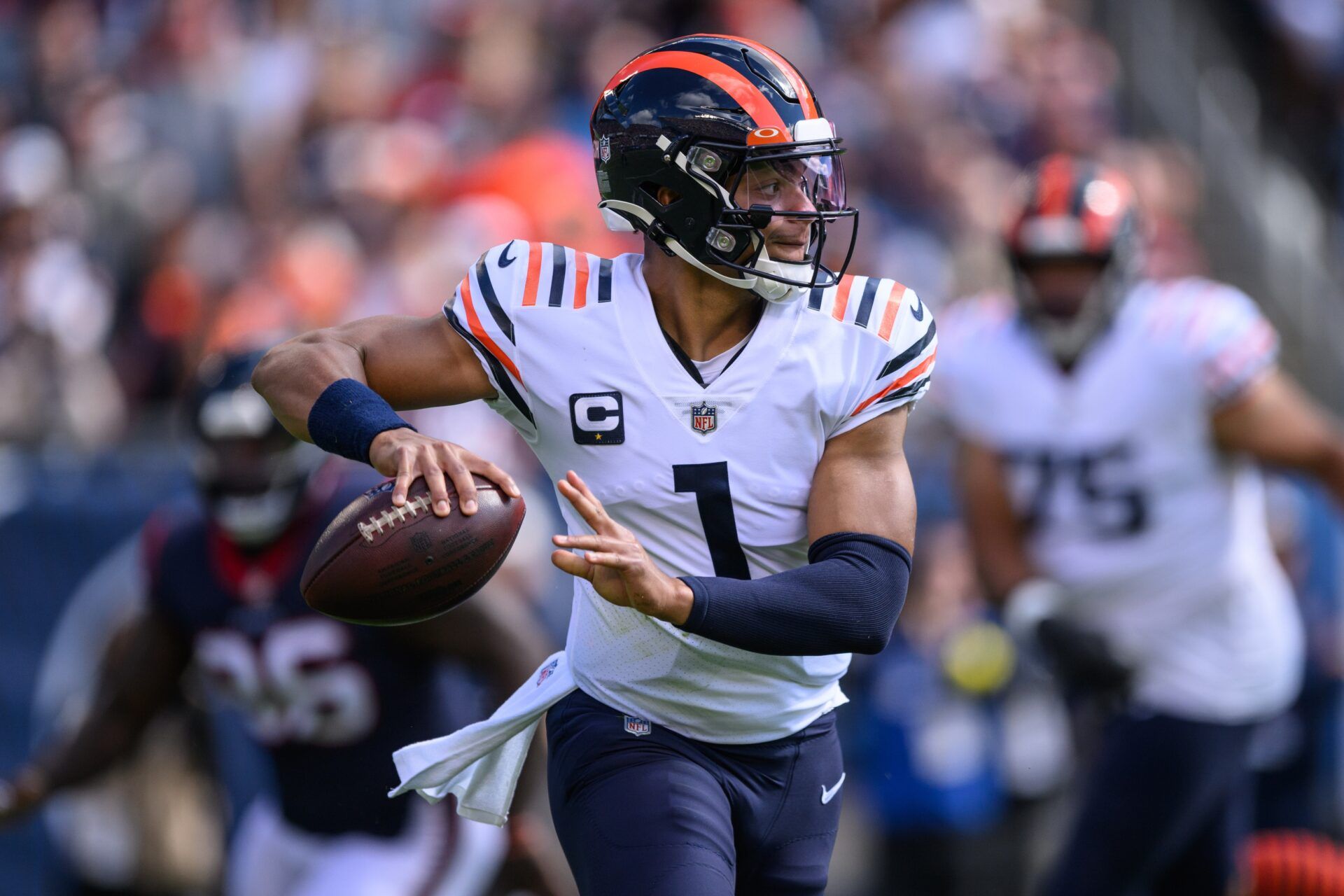 Justin Fields (1) looks to pass in the first quarter against the Houston Texans at Soldier Field.